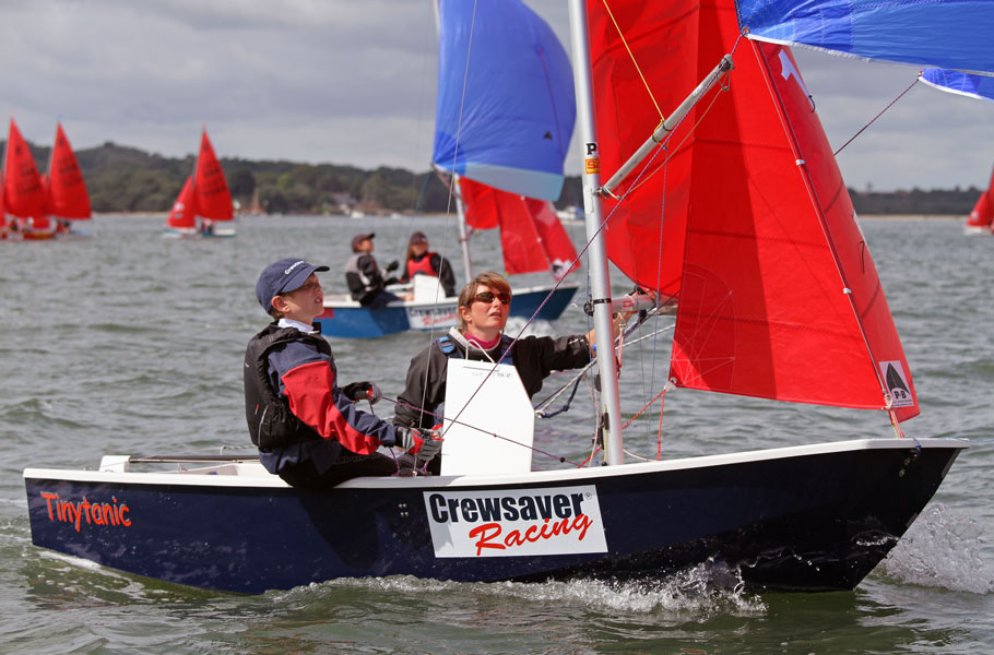 Sarah & George Richards racing 'Tinytanic' at the 2012 Europeans in Poole - Photo by Mike Millard A dark blue GRP Mirror dinghy racing with spinnaker up