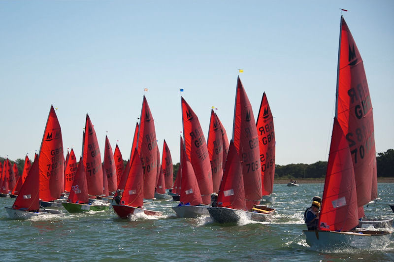 Mirror dinghies sailing on starboard tack at the start of a race
