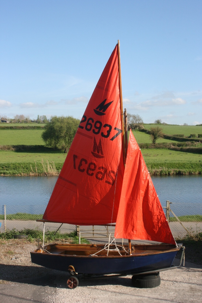 Mirror Dinghy rigged in dinghy park with river Avon in the background