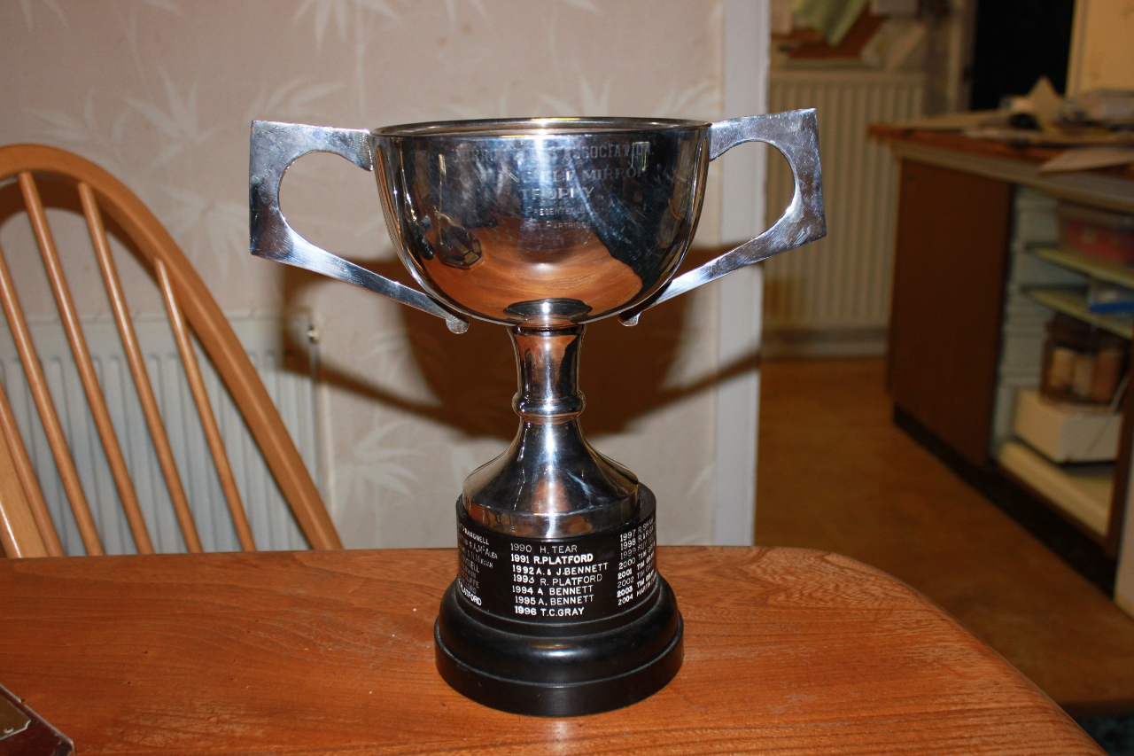 A silver cup with a black plastic base