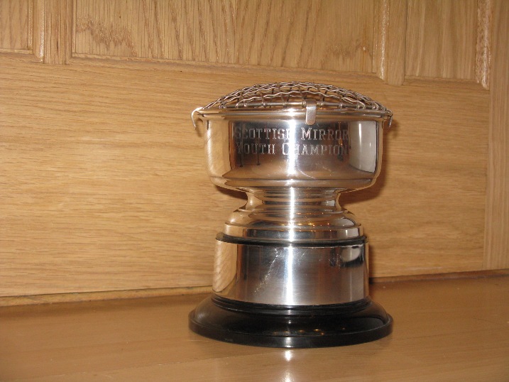 A silver cup with a plastic base and silver engraved ring