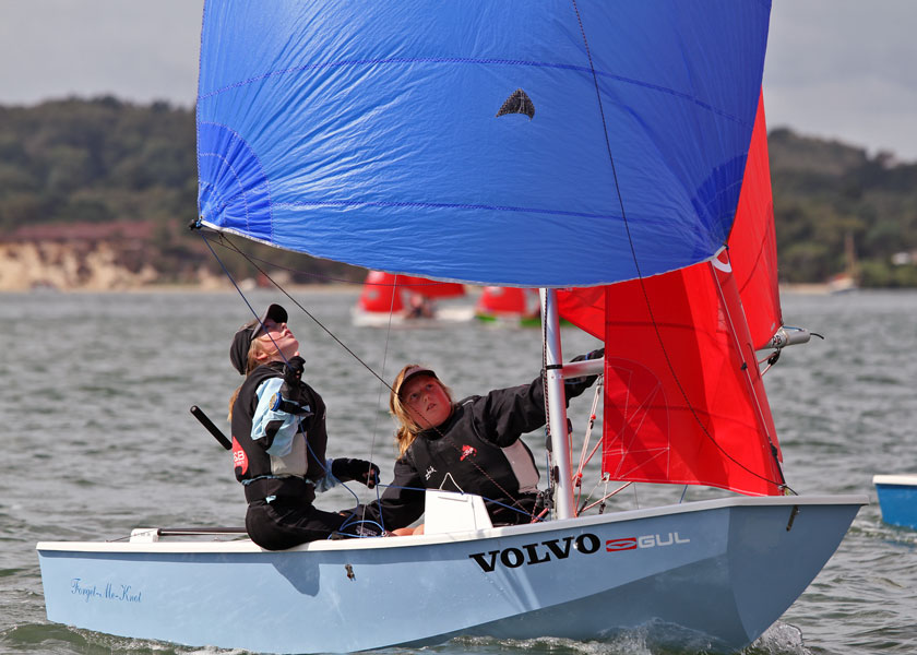 Blue Mirror dinghy with crew and helm fully focused on the spinnaker 
