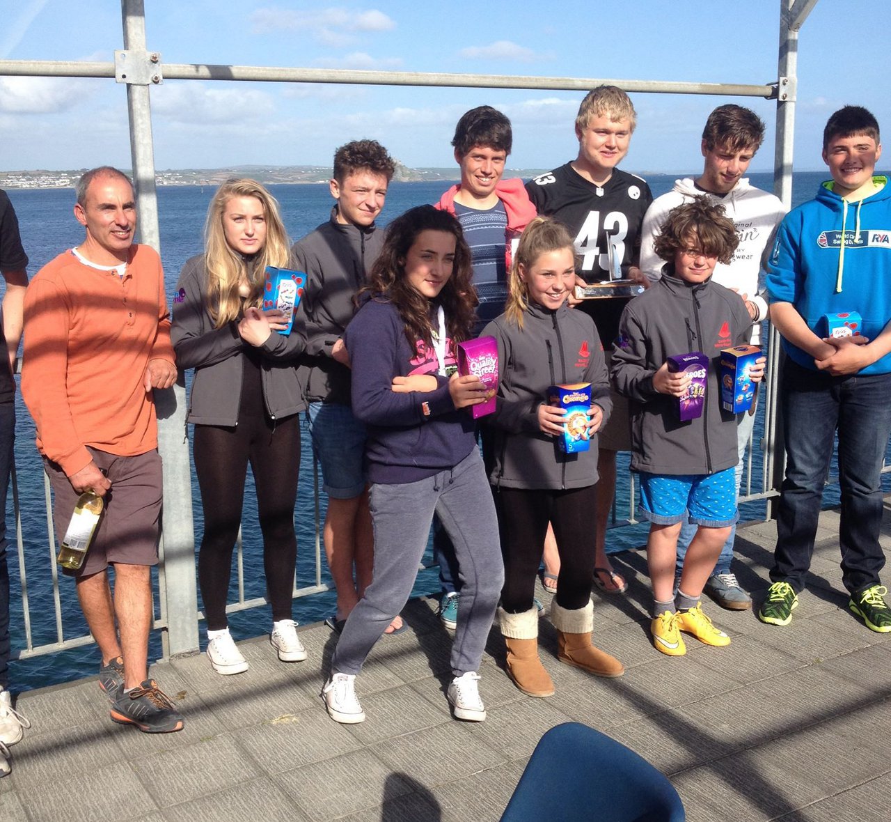 Mirror & Laser prize winners on a balcony with prizes