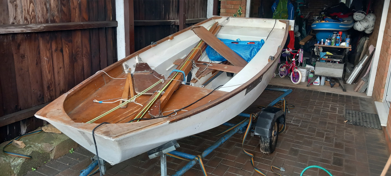 A Mirror dinghy on a road trailer with mast down