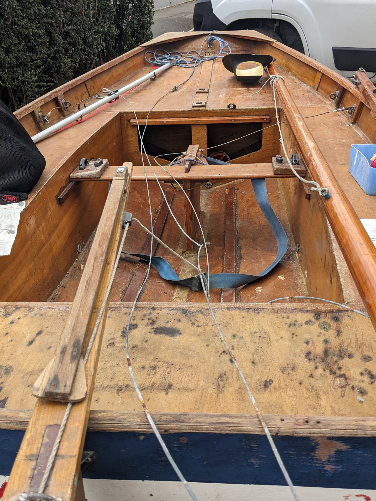 A wooden Mirror dinghy with mast down