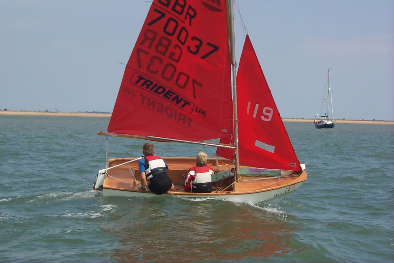 White wooden Mirror dinghy going into a roll tack