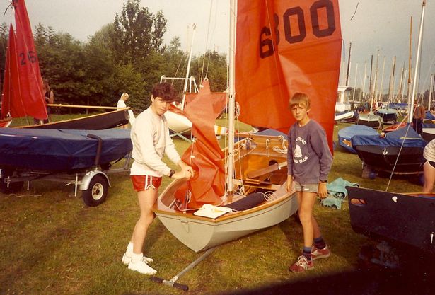 Two boys rigging up a Mirror dinghy